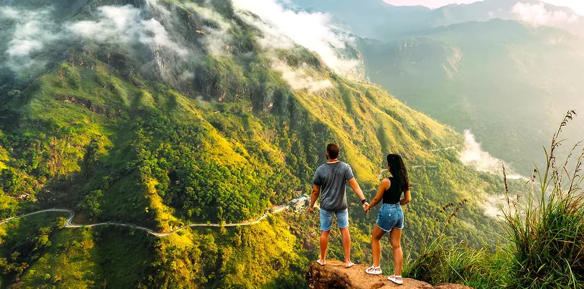 A couple overlooking Sri Lanka’s mist-covered hill country