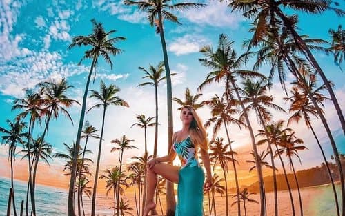 A traveller enjoying sunset on Sri Lanka’s tropical coast